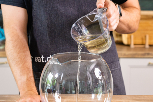 Weißwein in Bowlegefäß gießen