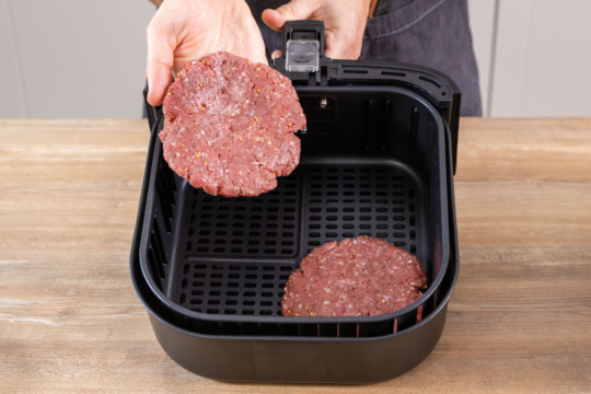 Burgerpatties in die Heißluftfritteuse geben