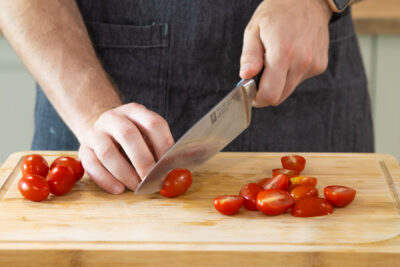 Die Tomaten in Stücke schneiden.