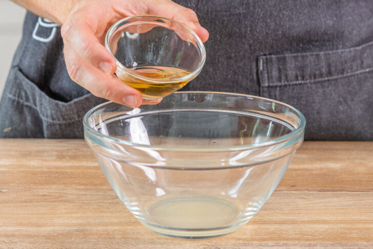 Essig zum Zitronensaft in die Schüssel geben, für eine schnelle Salatsauce
