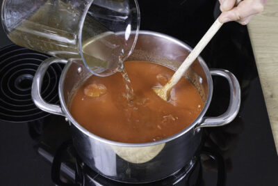 Geschälte Tomaten und Gemüse dazugießen und aufkochen