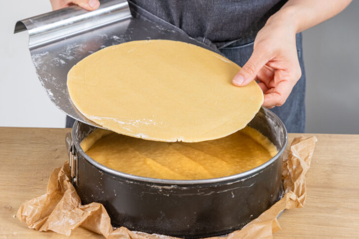 Teig als Decke auf Kuchen legen