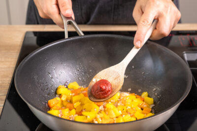 Tomatenmark zum Gemüse geben