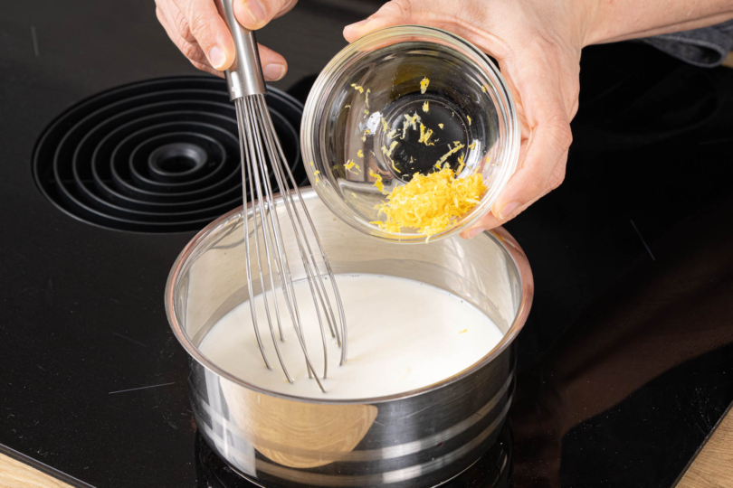 Zitronenschale in die Milch rühren und aufkochen