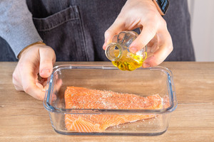 Olivenöl über den Lachs geben
