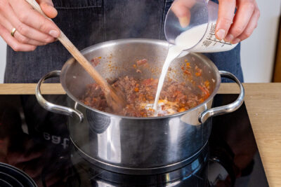 Milch zum Ragù alla bolognese gießen