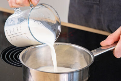 Milch in Topf gießen