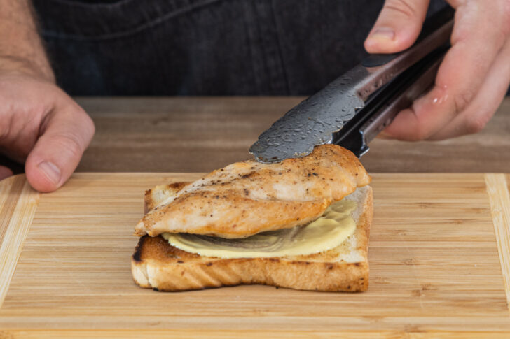 Die Hähnchenbrust auf die Toastscheibe legen