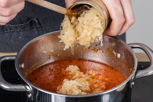Sauerkraut in den Topf geben