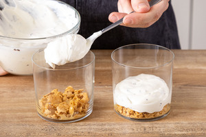 Quarkcreme ins Glas auf die Keksschicht geben