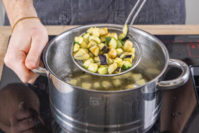 Zucchini- und Auberginewürfel im Topf frittieren