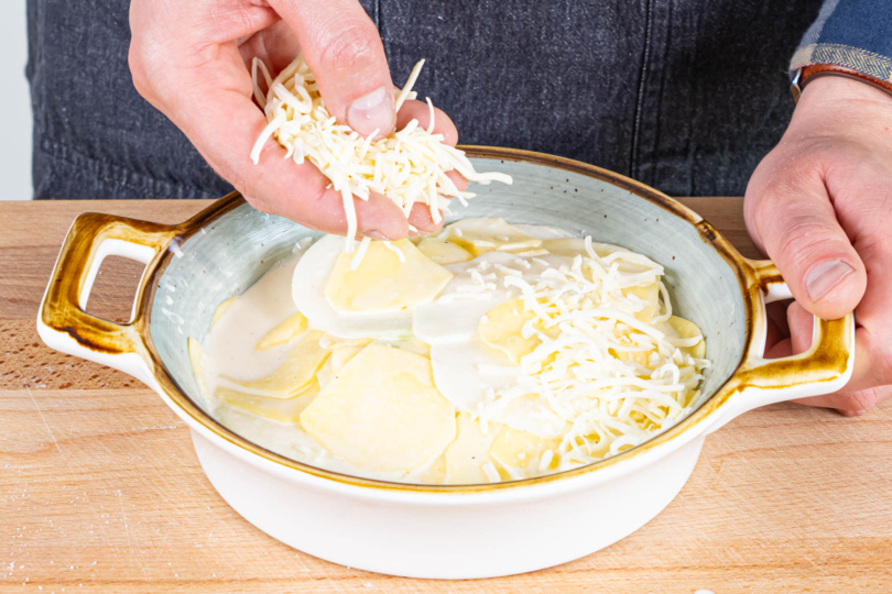 Kartoffel-Kohlrabi-Auflauf mit Käse bestreuen und überbacken