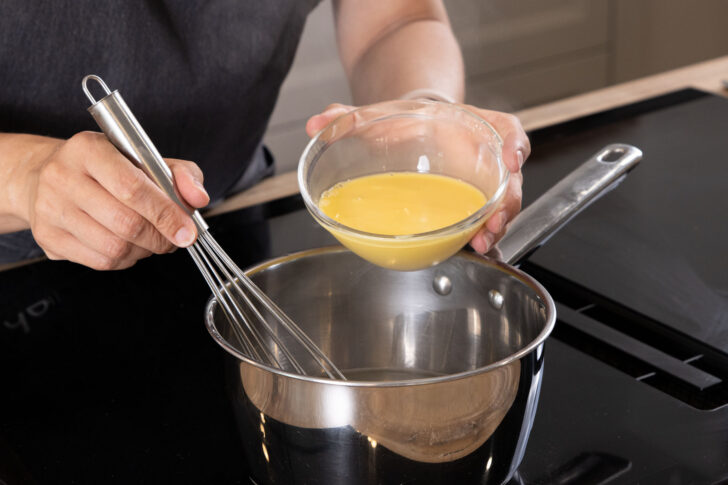 Das Puddingpulver zum Birnensaft geben.