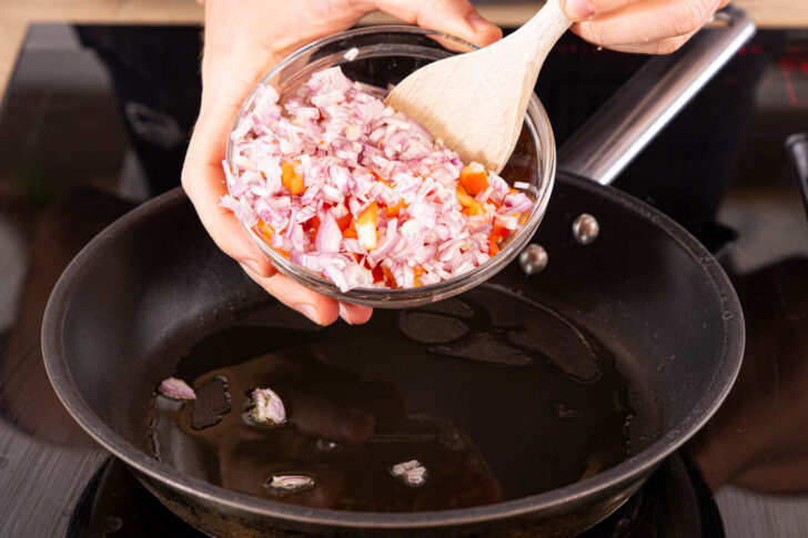 Zwiebel- und Paprikawürfel anbraten