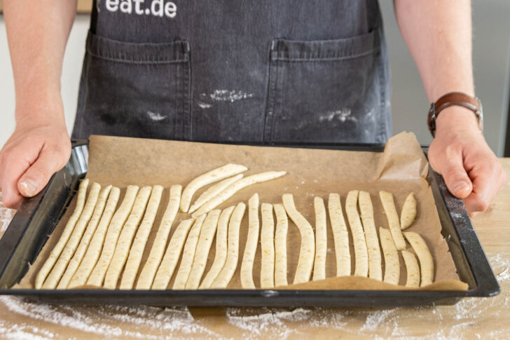 Brotsticks auf dem Blech verteilen