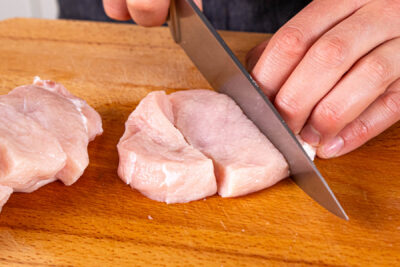 Schweinefleisch in Stücke schneiden