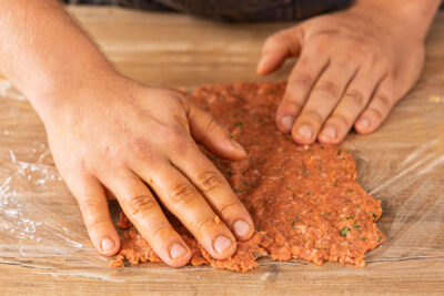 Hackfleisch auf Frischhaltefolie verteilen