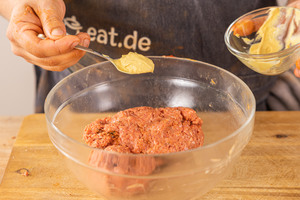 Hackfleisch mit Senf würzen