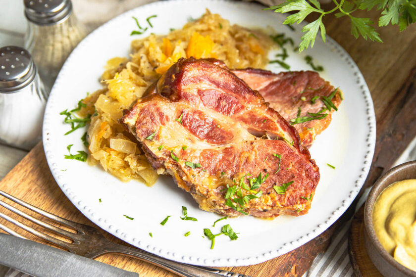 Kassler mit Sauerkraut aus dem Backofen auf Teller angerichtet