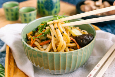 gebratene Udon-Nudeln nach japanischer Art mit Stäbchen essen