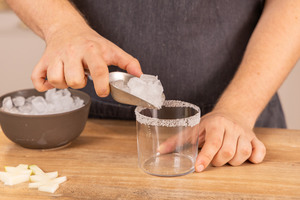 Eiswürfel ins Glas geben