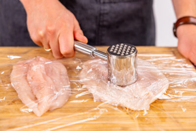 Fleisch mit Fleischklopfer plätten