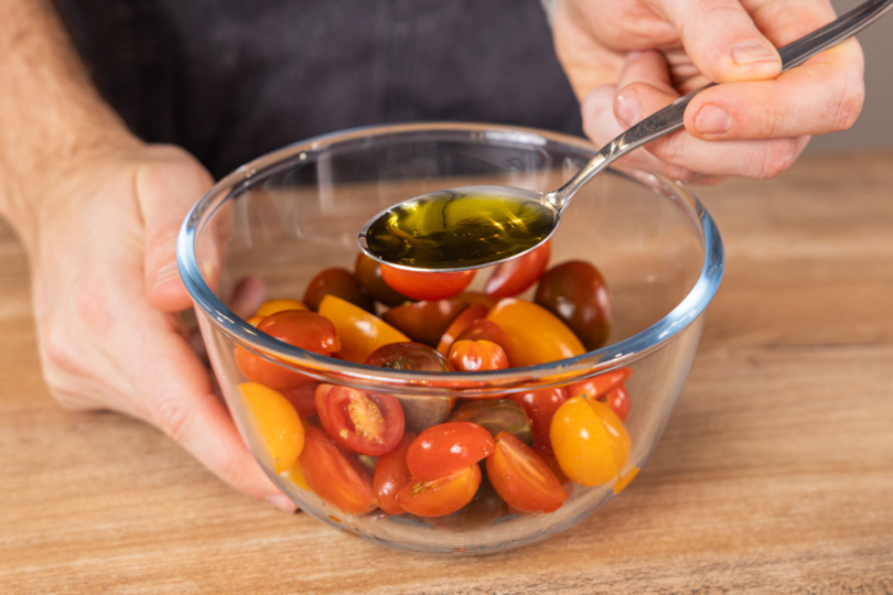 Olivenöl zu den Tomaten geben