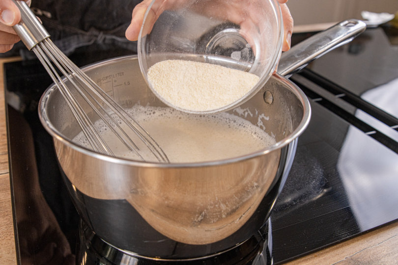 Grieß in die Milch rühren