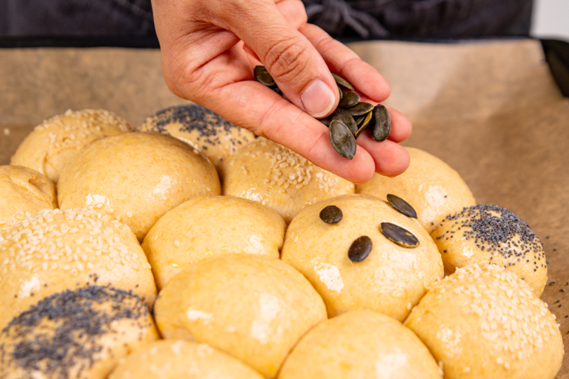 Toppings über Hefebrötchen verteilen