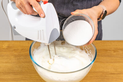Zucker in den Eischnee geben