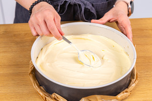 Cheesecakefüllung auf Keksboden verteilen