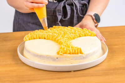 Buttercreme mit Spritzbeutel auftragen in Form eines Fuchskopfes