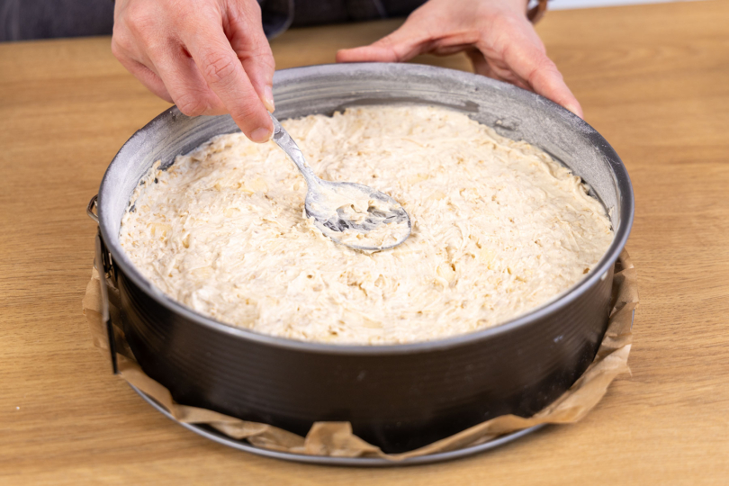 Teig für den Apfel-Haferflocken-Kuchen in die Springform füllen