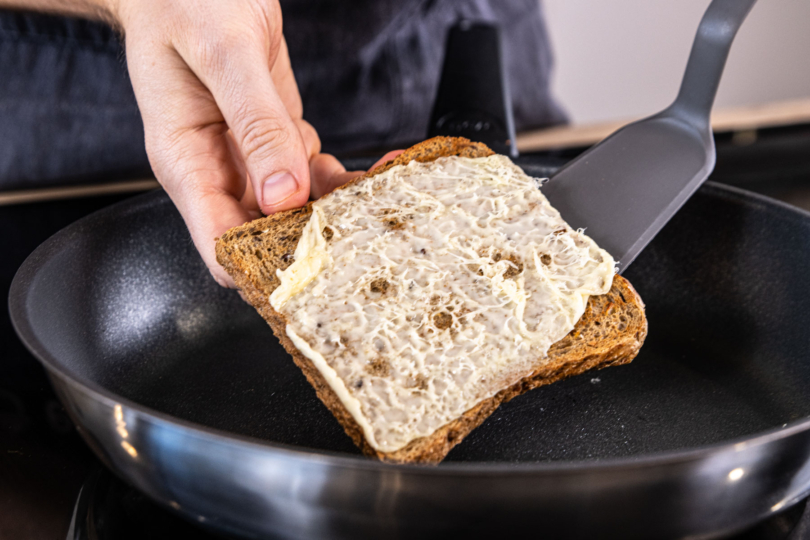 Toast zum Käse in die Pfanne geben