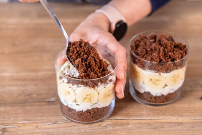 Maulwurfkuchen im Glas mit Kuchenkrümmeln bedecken