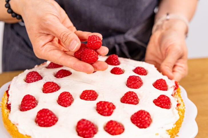 Himbeeren auf Tortencreme verteilen