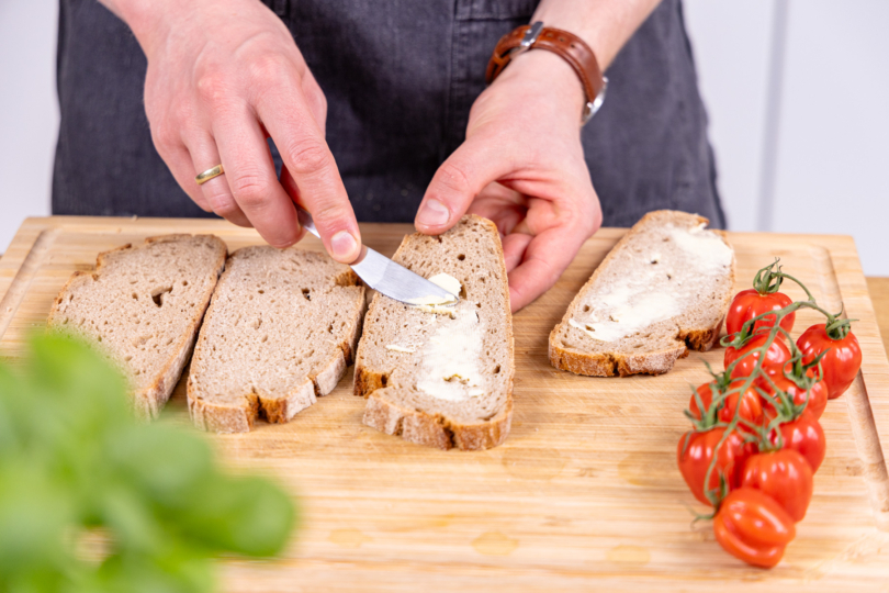 Brot mit Butter einstreichen