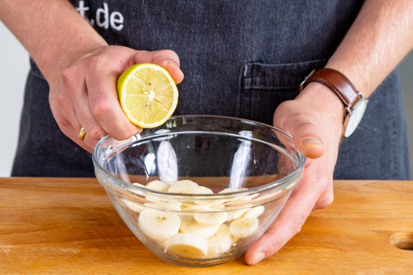 Bananenscheiben mit Zitronensaft beträufeln