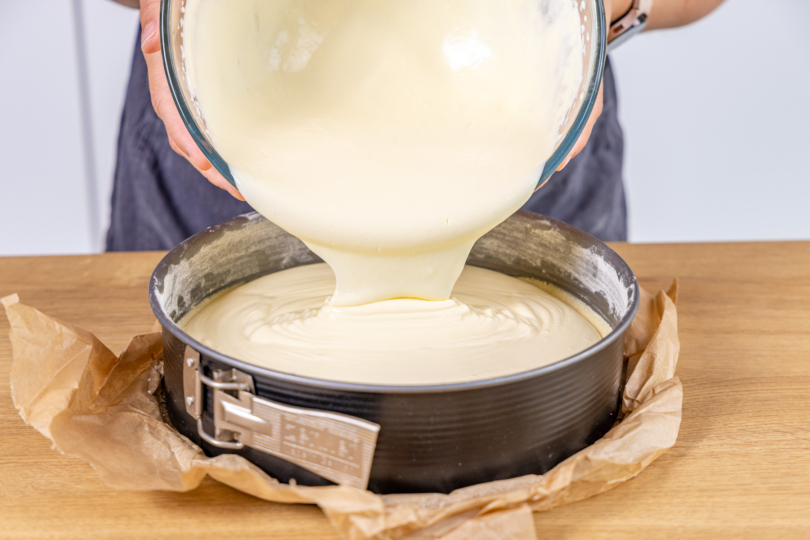 Käsekuchen-Masse in die Springform geben