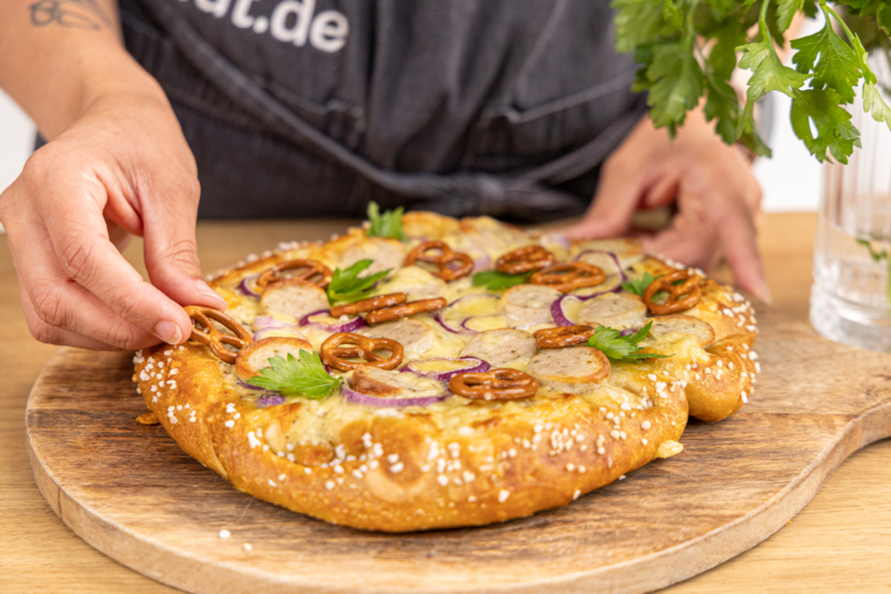 Brezelpizza garnieren
