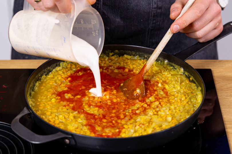 Kokosmilch und passierte Tomaten dazugeben