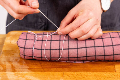 Fleisch im Tuch wickeln und binden