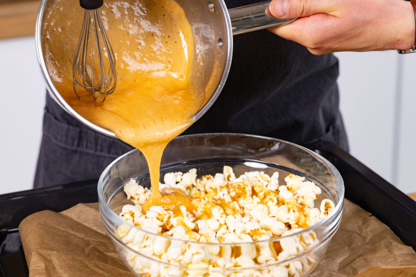 Karamell über das Popcorn geben.