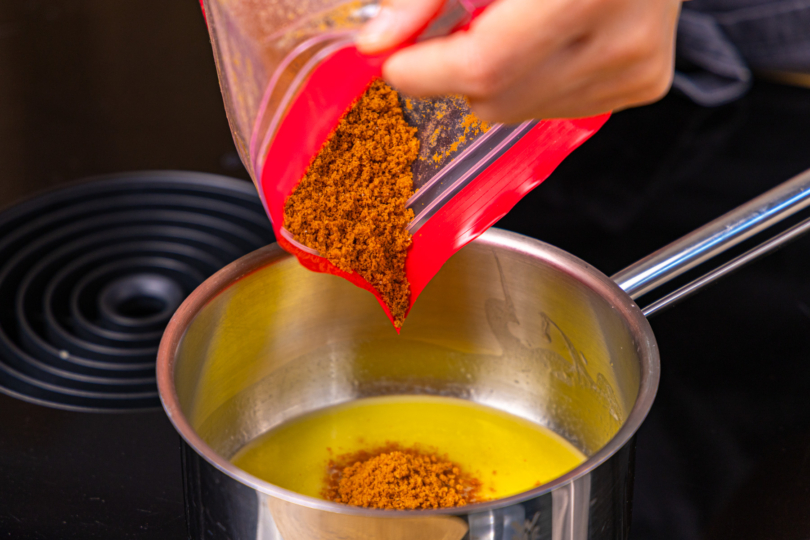 Keksbrösel in geschmolzene Butter geben