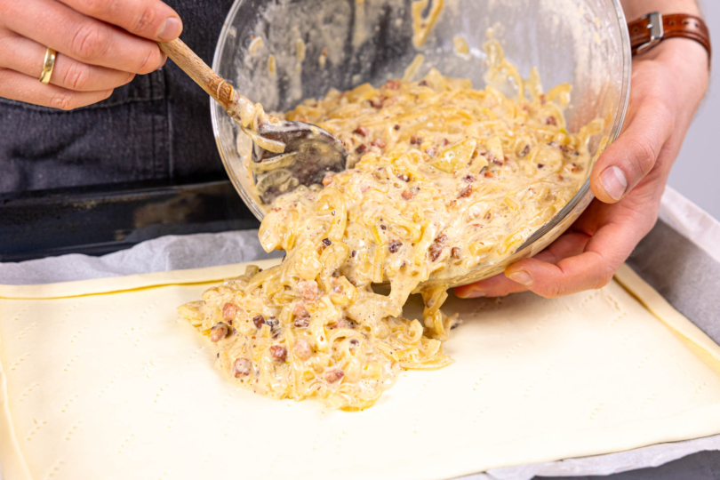 Zwiebelmasse auf Blätterteig verteilen