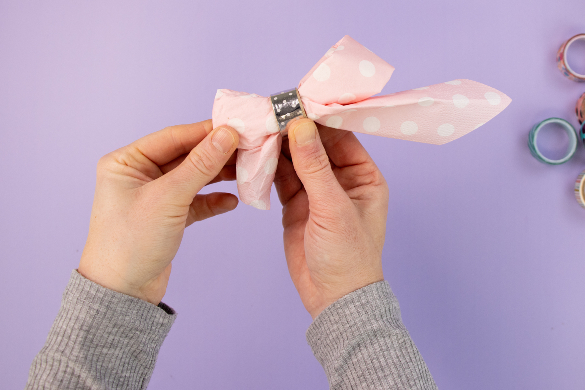 Serviette durch Serviettenring ziehen