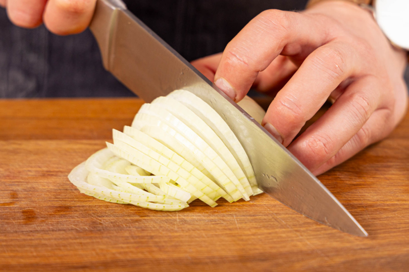 Gemüsezwiebeln halbieren und in Ringe schneiden