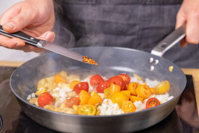 Chiliflocken in die Pfanne geben