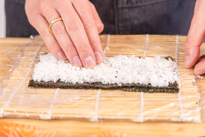 Reis auf Nori-Blatt andrücken