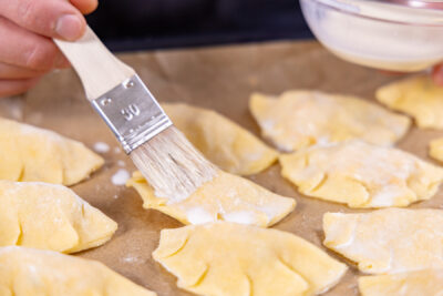 Vegetarische Empanadas mit Milch bestreichen